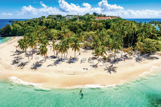 Karibische Insel mit Palmen und weißen Sandstränden umgeben vom Meer